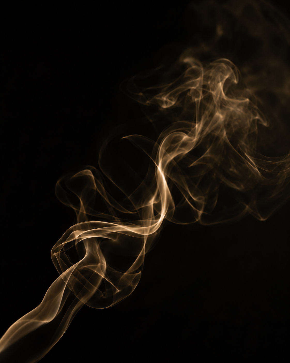 Golden aromatic smoke on a dark background